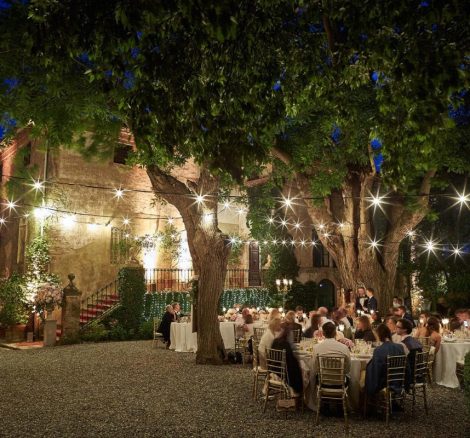 fairy lights draped overhead outside at wedding venue in Tuscany Italy Borgo Stomennano