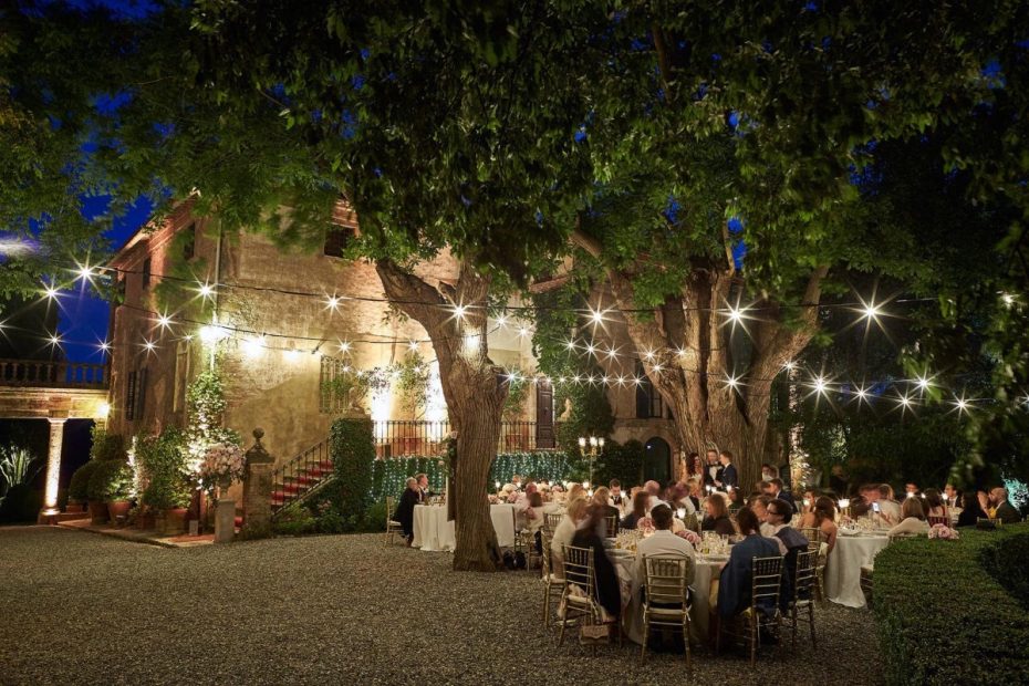 fairy lights draped overhead outside at wedding venue in Tuscany Italy Borgo Stomennano