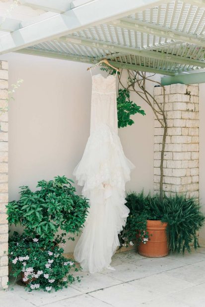 brides dress hung outside at wedding venue villa in corfu Greece at villa Sylva