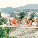 wedding guests sat on terrace with sea view at wedding venue villa in corfu Greece at villa Sylva