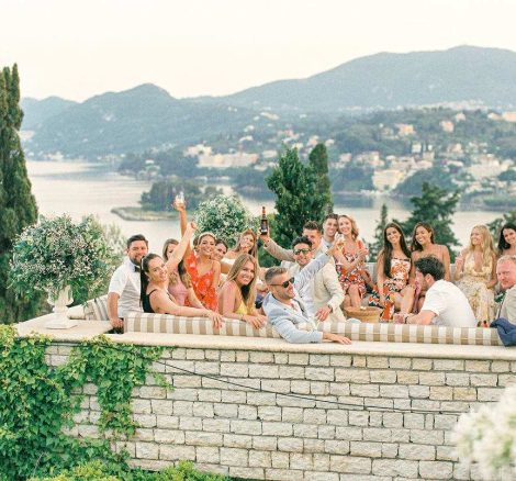 wedding guests sat on terrace with sea view at wedding venue villa in corfu Greece at villa Sylva