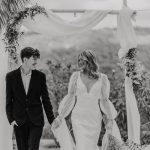 black and white photo of bride and groom walking back down the aisle together hand in hand at ibiza wedding venue kazamor ibiza