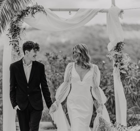 black and white photo of bride and groom walking back down the aisle together hand in hand at ibiza wedding venue kazamor ibiza