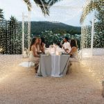 wedding guests dining under fairy lights at ibiza wedding venue kazamor ibiza