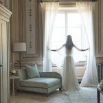 Bride in Heritage Suite at Window at luxury wedding venue in Tuscany COMO Castello Del Nero