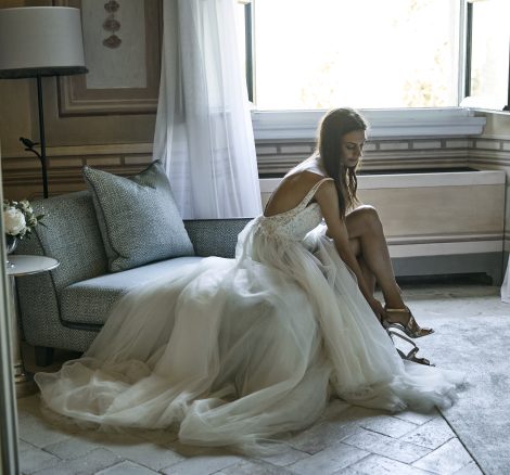 bride getting dressed at luxury wedding venue in Tuscany COMO Castello Del Nero
