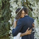 Couple Embrace under Wedding Arch at luxury wedding venue in Tuscany COMO Castello Del Nero