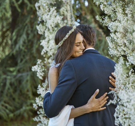 Couple Embrace under Wedding Arch at luxury wedding venue in Tuscany COMO Castello Del Nero