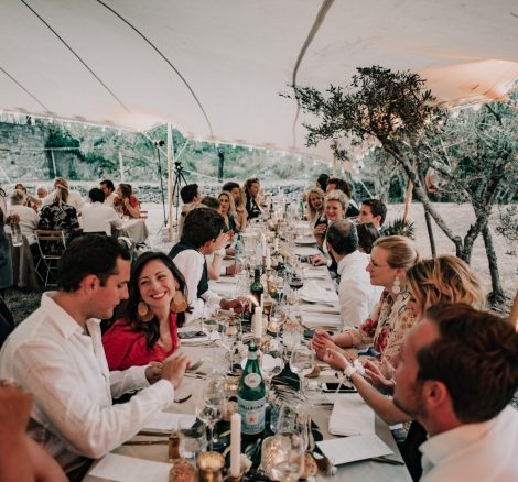 wedding guests dining under tipi style marquee at at wedding venue in france provence le domaine du rey