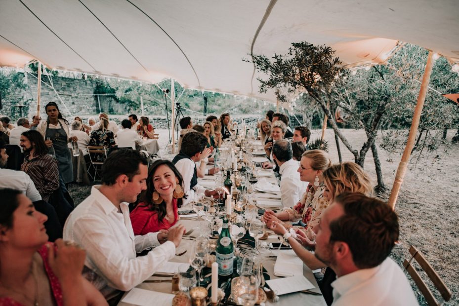 wedding guests dining under tipi style marquee at at wedding venue in france provence le domaine du rey