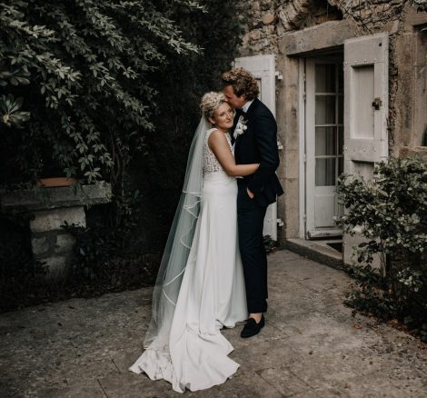 bride and groom stood outside rustic wedding venue domaine du rey in provence