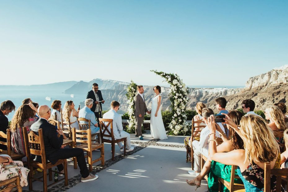 bride and groom exchanging vows clifftop ceremony at wedding venue in Santorini venetsanos winery