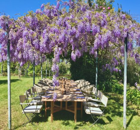 overhanging purple flowers over wedding table at wedding venue villa in corfu Greece at villa Sylva