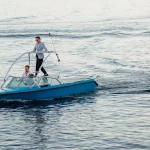 Image of groom arriving by boat at wedding venue The Peligoni Club