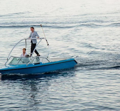 Image of groom arriving by boat at wedding venue The Peligoni Club