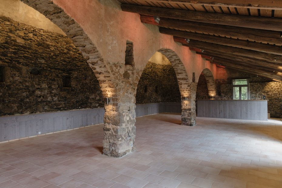 arched stone structure inside beautifully restored barn at wedding venue in france provence le domaine du rey