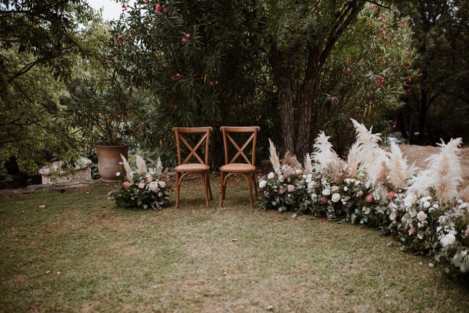 wooden benches and pampas for wedding ceremony outside at wedding venue in france provence
