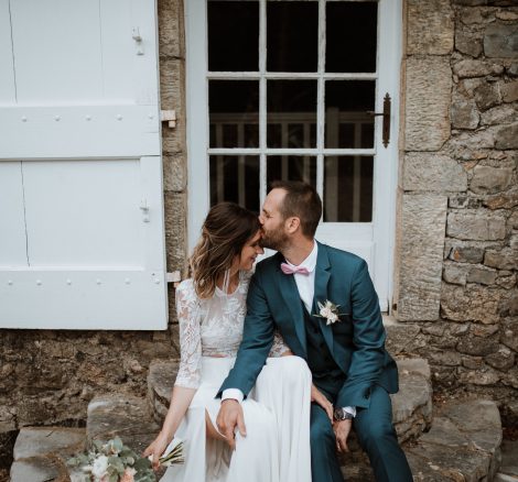groom kissing brides forehead at wedding venue in france provence