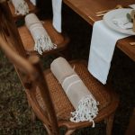 blankets rolled up as a gift on wedding guests chairs at wedding venue in france provence