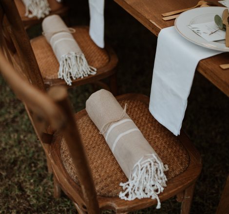 blankets rolled up as a gift on wedding guests chairs at wedding venue in france provence