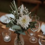 close up of flowers in glass vase on wedding tables at wedding venue in france provence