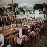 wooden chairs and tables at wedding venue in france provence