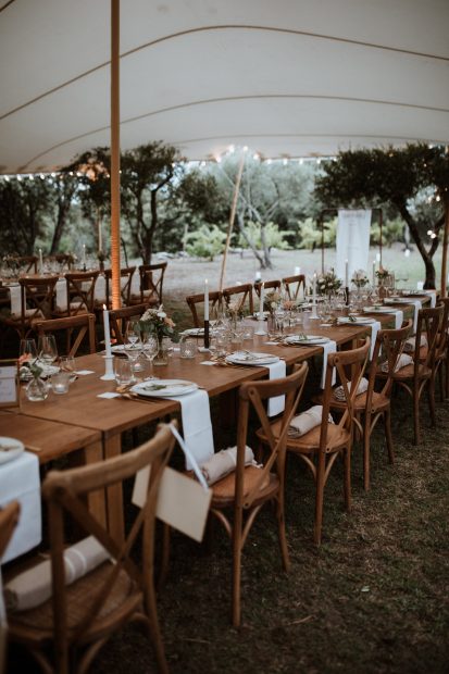 wooden chairs and tables at wedding venue in france provence