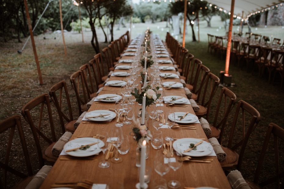 wooden tables under marquee at wedding venue in france provence