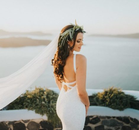 bride in stunning grace loves lace wedding dress at wedding venue in Santorini venetsanos winery