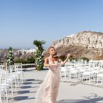 violist playing as bride prepares to walk down the aisle at wedding venue in Santorini venetsanos winery