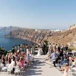 wedding ceremony at open air winery wedding venue in Santorini Greece venetsanos winery