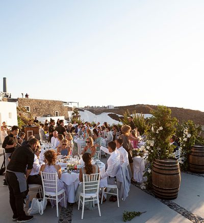 wedding guests seated for wedding breakfast at wedding venue in Santorini venetsanos winery