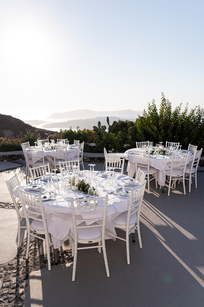 round wedding tables at wedding venue in Santorini venetsanos winery