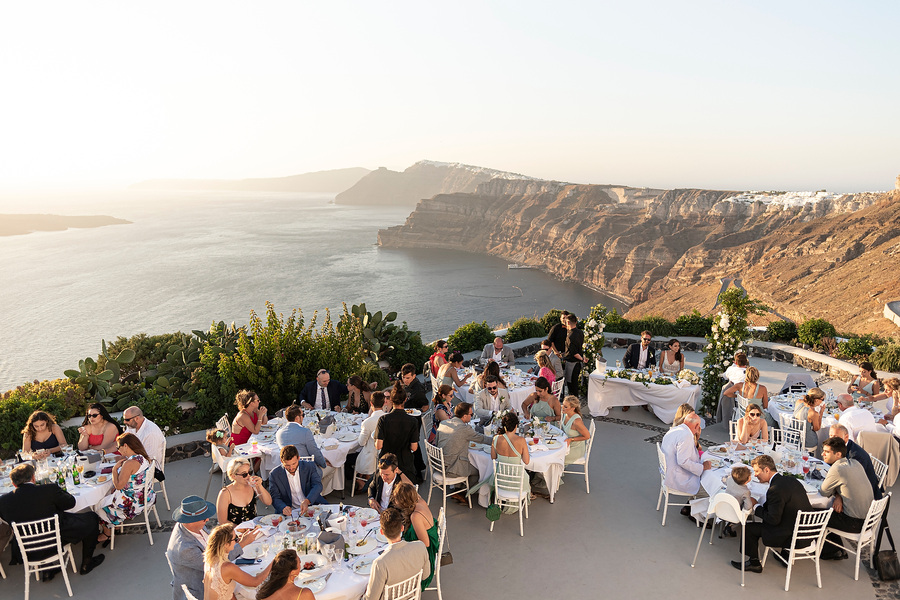 guests seated for wedding breakfast at wedding venue in Santorini venetsanos winery