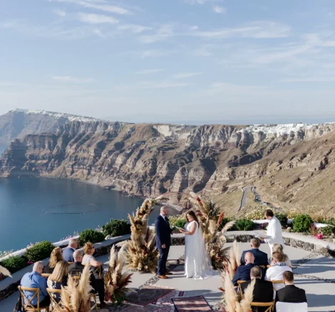 bride and groom exchange vows on cliff edge with sea view at wedding venue in Santorini venetsanos winery