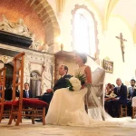 bride and groom during wedding ceremony at church at chateau wedding venue in france chateau de vallery