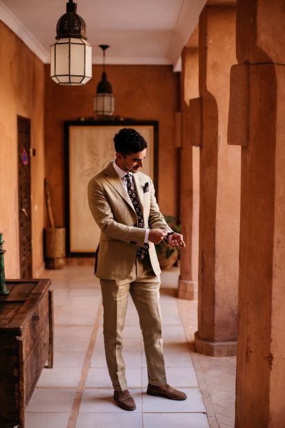 groom getting dressed at unique wedding venue in morocco kasbah bab ourika