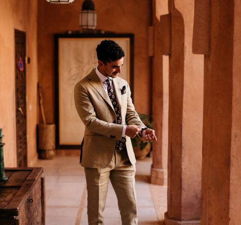 groom getting dressed at unique wedding venue in morocco kasbah bab ourika