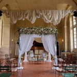 wedding ceremony inside the hall at chateau wedding venue in france chateau de vallery