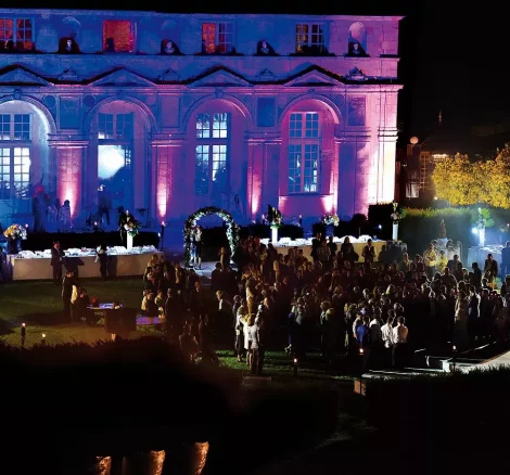 night time light display against the chateau at chateau wedding venue in france chateau de vallery