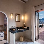 en suite with balcony and view of atlas mountains at unique wedding venue in morocco kasbah bab ourika
