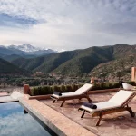 pool and loungers that look out over atlas mountains at unique wedding venue in morocco kasbah bab ourika