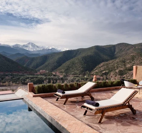 pool and loungers that look out over atlas mountains at unique wedding venue in morocco kasbah bab ourika