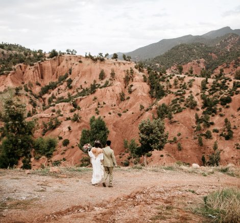 bride and groom walking through the atlas mountains at unique wedding venue in morocco kasbah bab ourika