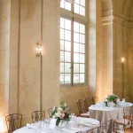wedding dinner set up inside at chateau wedding venue in france chateau de vallery