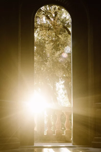 sun shining through the doorway at wedding venue in tuscany villa lena