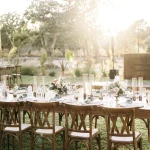 wooden chairs and table set up outside for wedding guests at unique wedding venue baja luna in mexico