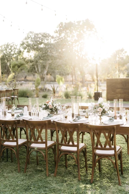 wooden chairs and table set up outside for wedding guests at unique wedding venue baja luna in mexico