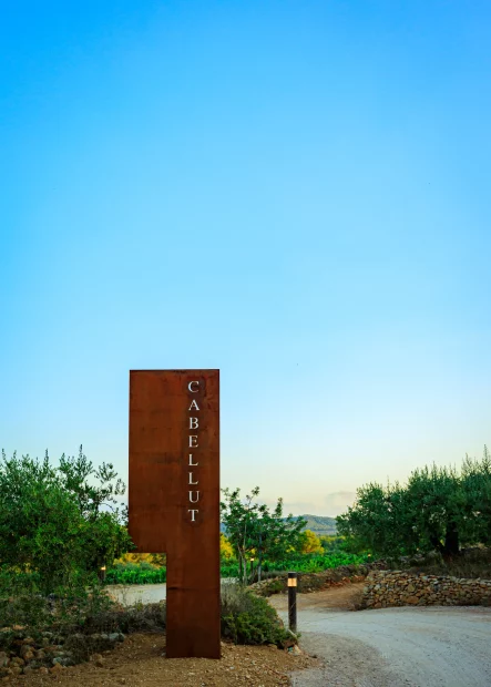 rusted sign at the entrance to the best vineyard wedding venue in Barcelona Spain Masia Cabellut