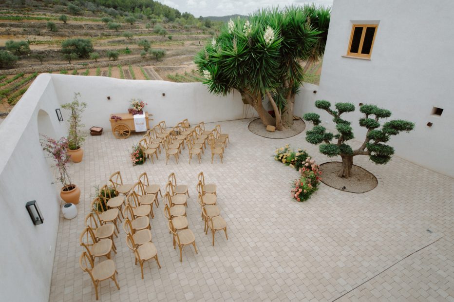 Wedding Ceremony with wooden chairs and a bonsai tree alter at Vineyard Wedding Venue Barcelona Masia Cabellut